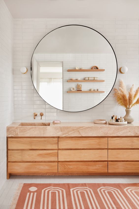 Statement circular mirror in minimalist bathroom design